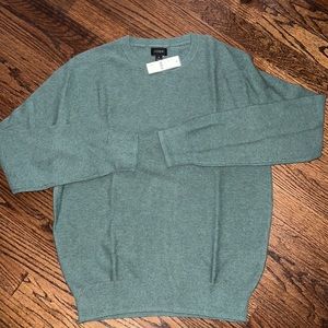 Light weight sweater in a sea foam green color.